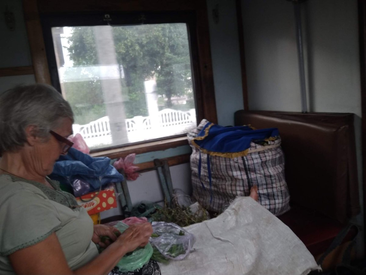 Bábuška s mnohými zavazadly v úzkém motoráčku 