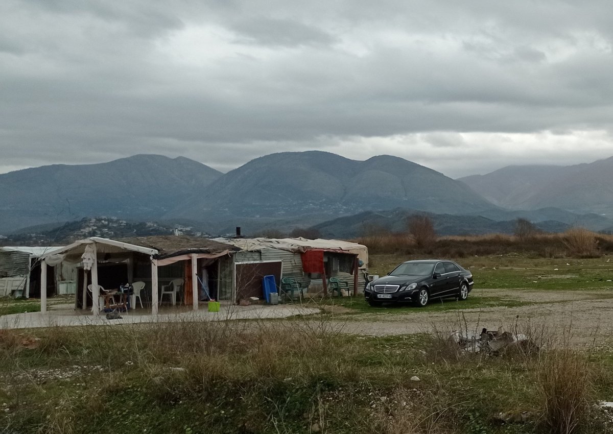 Naleštěný Mercedes před chatrčí z vlnitého plechu