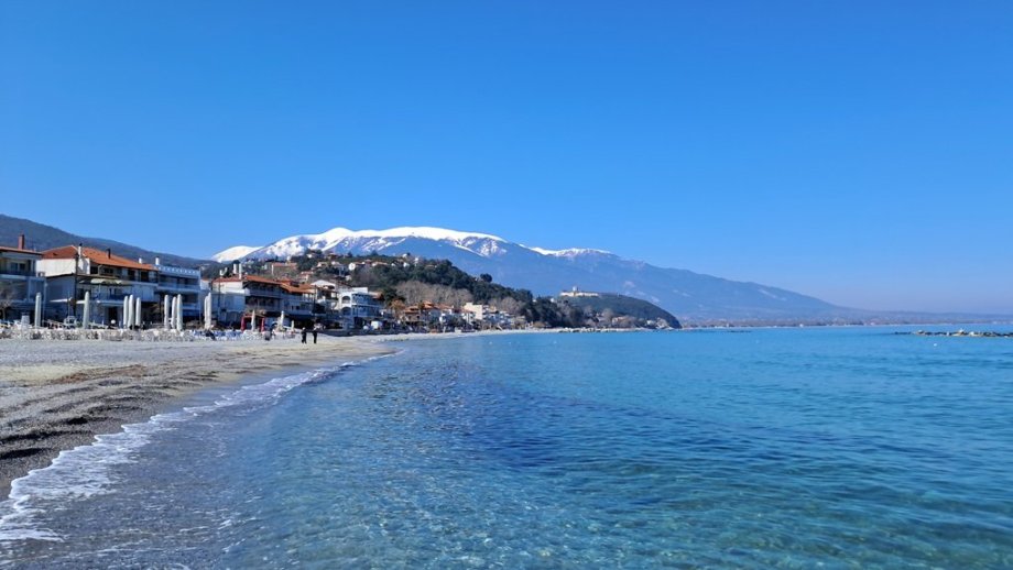 Průzračně čisté moře a zasněžené pohoří Olymp v pozadí